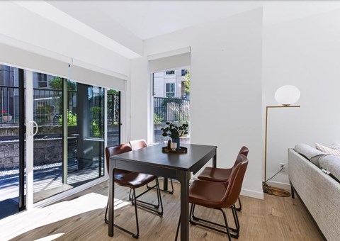 A modern dining room with a table and chairs.