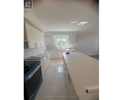 A kitchen with white cabinets and a black stove top oven.