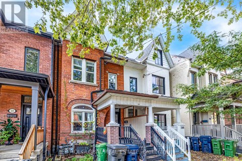 A row of houses with a tree in front.