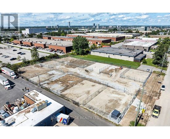 An aerial view of a large industrial area with a sign that reads "ROYALTON REALTY LTD."