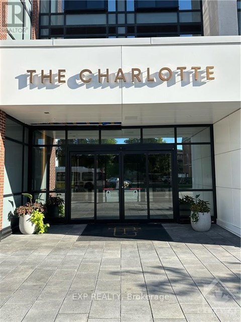 The Charlotte building has a glass entrance and a white wall.
