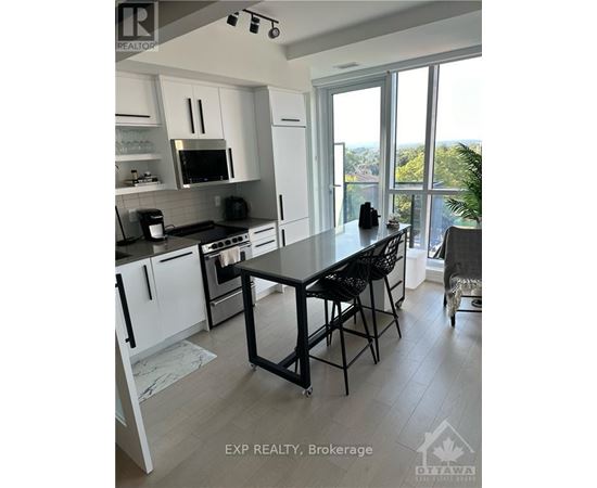 A kitchen with a table and chairs in front of a window.