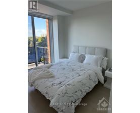 A bedroom with a large bed and a view of the city.