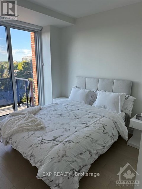 A bedroom with a large bed and a view of the city.