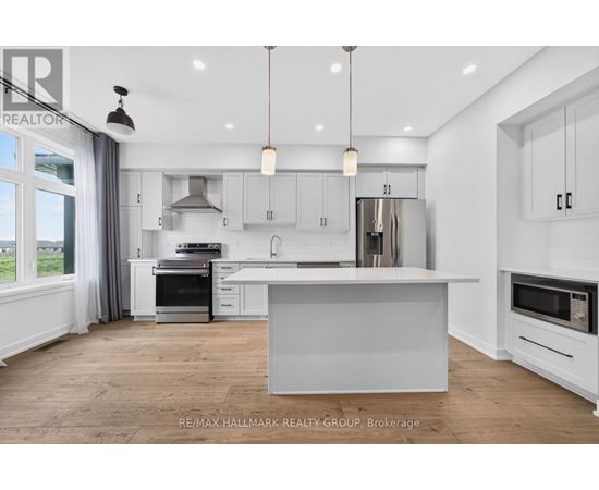 A modern kitchen with white cabinets and a large island.