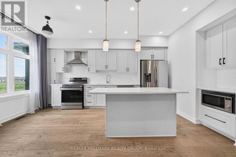 A modern kitchen with white cabinets and a large island.