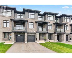 A large, modern building with a sign that reads RE/MAX Hallmark Realty Group, Brokerage.