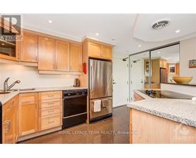 A modern kitchen with wooden cabinets and stainless steel appliances.