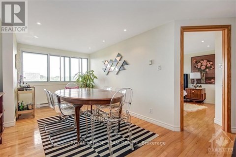 A dining room with a wooden table and chairs.
