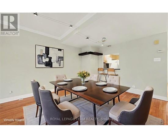 A dining room with a table set for four.