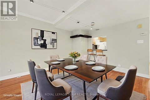 A dining room with a table set for four.