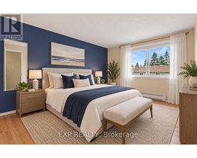 A bedroom with a bed, nightstand, and window.