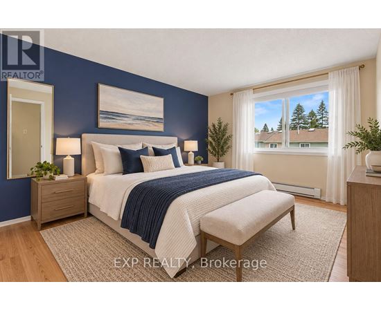 A bedroom with a bed, nightstand, and window.