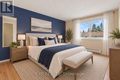 A bedroom with a bed, nightstand, and window.