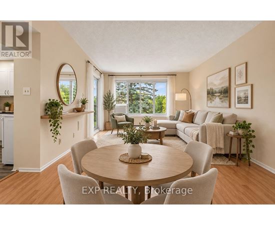 A well-lit, spacious living room with a dining table and chairs, and a couch with pillows.