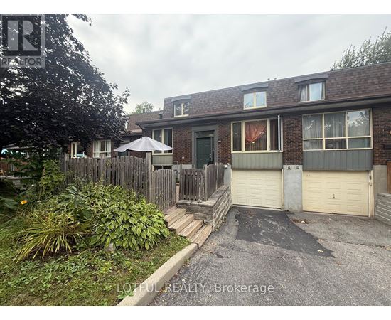 A house with a brown roof and a white garage door.