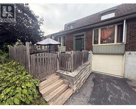 A house with a wooden fence and a patio umbrella.