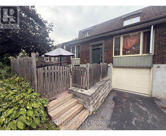 A house with a wooden fence and a patio umbrella.