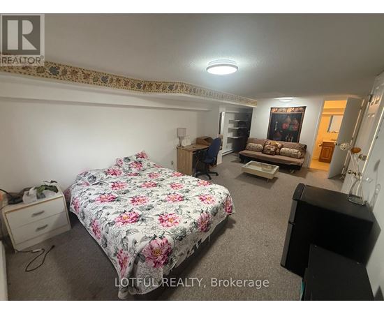 A bedroom with a floral bedspread and a bed in the center of the room.