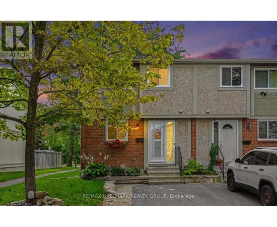 A house with a tree in front of it and a car parked in the driveway.
