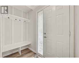 A white door with a glass panel is in a room with white walls.