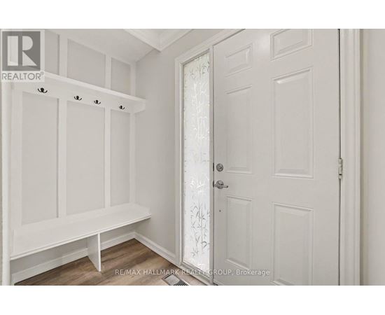 A white door with a glass panel is in a room with white walls.