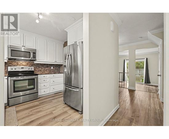 A kitchen with white cabinets and stainless steel appliances.