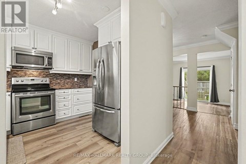 A kitchen with white cabinets and stainless steel appliances.