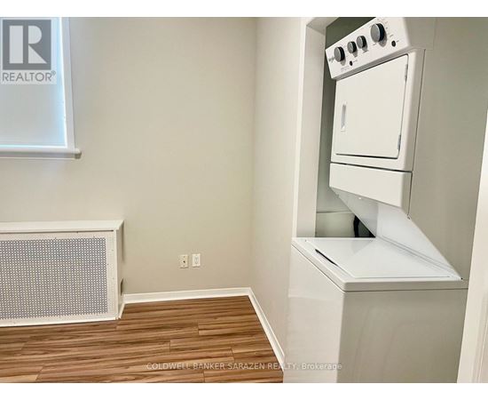 A small kitchen with a white oven and a radiator.