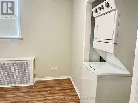 A small kitchen with a white oven and a radiator.
