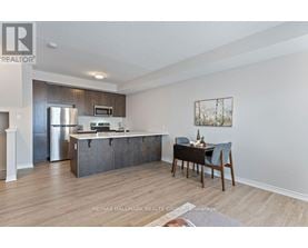 A kitchen with a dining table and chairs in the foreground.