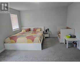 A bedroom with a bed, nightstand, and a small table.