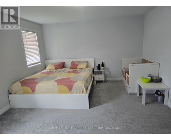 A bedroom with a bed, nightstand, and a small table.
