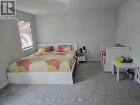 A bedroom with a bed, nightstand, and a small table.