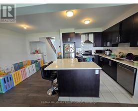 A kitchen with a black counter and a white island.