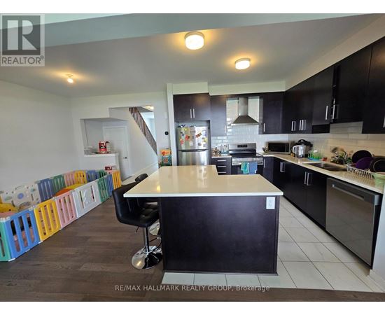 A kitchen with a black counter and a white island.