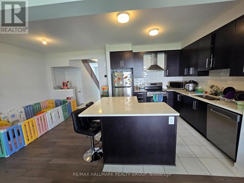 A kitchen with a black counter and a white island.