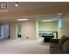 A room with a pool table and a couch.