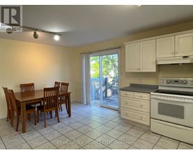 A kitchen with a table and chairs and a stove top oven.