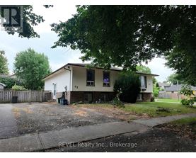 A house with a sign that says REVEL Realty Inc., Brokerage.
