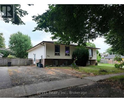 A house with a sign that says REVEL Realty Inc., Brokerage.