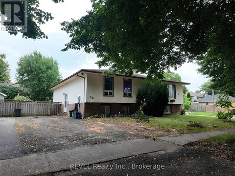 A house with a sign that says REVEL Realty Inc., Brokerage.