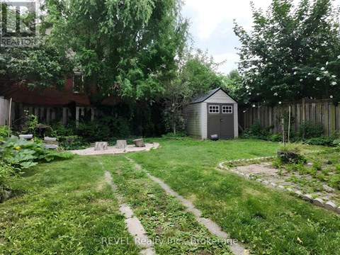 A backyard with a shed and a garden.