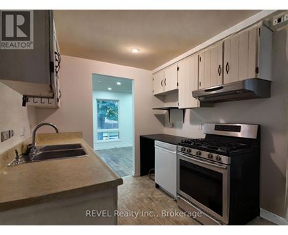 A kitchen with a stove and sink.