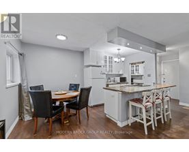 A modern kitchen with a dining table and chairs.