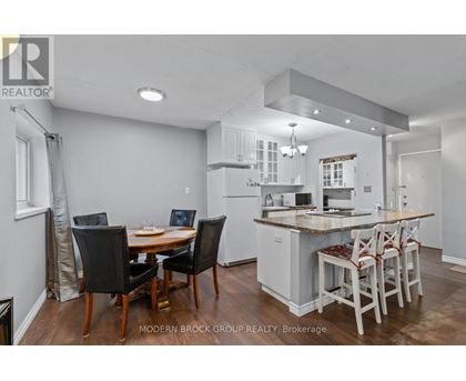 A modern kitchen with a dining table and chairs.