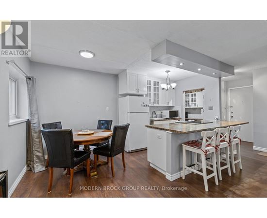 A modern kitchen with a dining table and chairs.