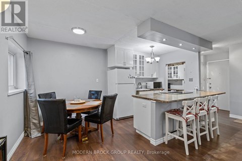 A modern kitchen with a dining table and chairs.