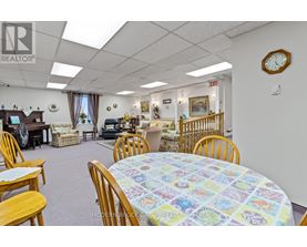 A dining room with a round table and chairs.