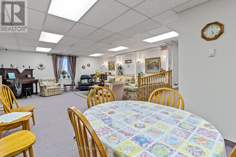 A dining room with a round table and chairs.